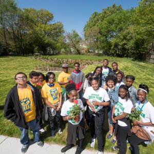 Youth stand in front of a new bioretention garden in Detroit