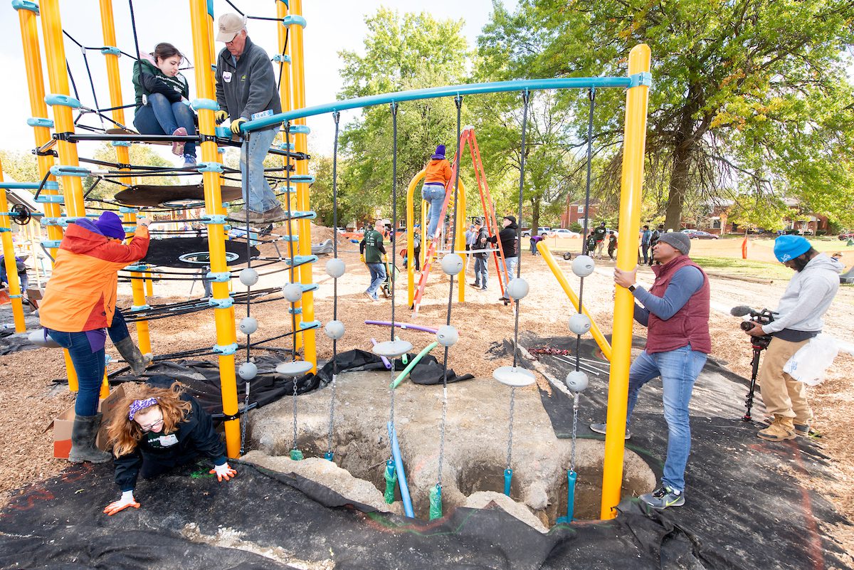 Volunteers construct one of the obstacle courses on the playground