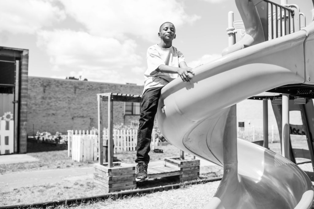 Boy sitting on top of playscape