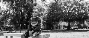 Boy sits on a park bench