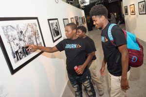MBK Detroit participants interact with photos on display at the exhibit